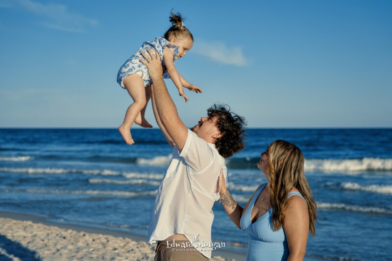 Gulf Shores family portrait Holding the baby up in the air 